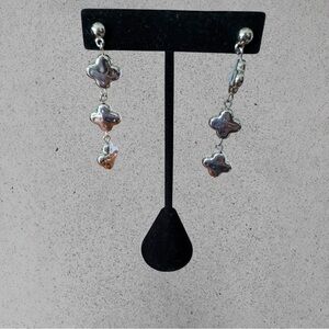 Pair of Silver colored post back earrings with 3 dangling clover shapes. NWOT